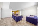 Open living room with tiled floors and stylish sofas at 1233 Nelson Park Court, Poinciana, FL 34759