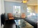 Cozy living room with two armchairs and a glass coffee table at 306 Athabasca Pl, Kissimmee, FL 34759