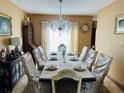 Elegant dining room featuring a chandelier and a large table at 306 Athabasca Pl, Kissimmee, FL 34759