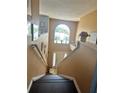 Dark wood staircase leading to the upper level of the home at 306 Athabasca Pl, Kissimmee, FL 34759