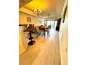 Bright dining room with hardwood floors and chandelier at 7652 Whisper Way # 302, Reunion, FL 34747