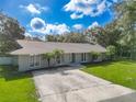 Ranch-style home with a large backyard and driveway at 601 Marlin Rd, Winter Springs, FL 32708