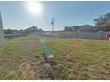 Backyard with a seesaw and partial view of a fence at 181 Silver Maple Bnd, Davenport, FL 33837