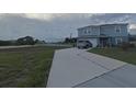 Two-story house with gray siding and a driveway; nice landscaping at 181 Silver Maple Bnd, Davenport, FL 33837