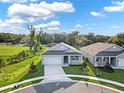 Aerial view of a modern house with a two-car garage and landscaping at 506 Ellie Ct, Apopka, FL 32703