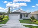 Modern house exterior with a two-car garage and landscaping at 506 Ellie Ct, Apopka, FL 32703