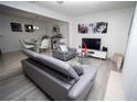 Open living and dining area with gray couches and white chairs at 435 Caribbean Dr, Davenport, FL 33897