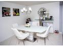 Modern dining room with white table and chairs at 435 Caribbean Dr, Davenport, FL 33897