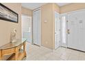 Bright entryway with tile flooring, storage closet, and glass-top accent table at 401 New Providence Promenade # 12401, Davenport, FL 33897
