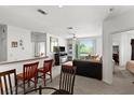 Open living room features a fireplace, sliding glass doors, and a partial kitchen view at 8810 Dunes Ct # 203, Kissimmee, FL 34747