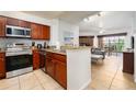Open kitchen with stainless steel appliances and wood cabinets at 8763 Worldquest Blvd # 5406, Orlando, FL 32821