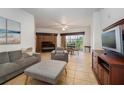 Spacious living room with gray sofa and access to a balcony at 8763 Worldquest Blvd # 5406, Orlando, FL 32821