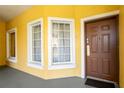 Bright condo entry with brown door and white-trimmed windows at 8763 Worldquest Blvd # 5406, Orlando, FL 32821