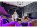 Living room with dark walls, damask wallpaper, and gothic-style furniture at 315 Lucaya Loop # 315, Davenport, FL 33897