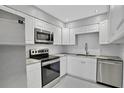 Modern kitchen with stainless steel appliances and white cabinets at 540 Orange Dr # 13, Altamonte Springs, FL 32701
