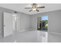 Bright bedroom with ceiling fan, tiled floors and sliding glass door at 540 Orange Dr # 13, Altamonte Springs, FL 32701