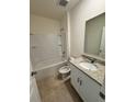 Clean bathroom with a tub, toilet, vanity with granite countertop at 1305 Morning Walk Dr, Ormond Beach, FL 32174