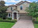 Two-story house with a large yard and brick driveway at 1424 Rolling Fairway Dr, Davenport, FL 33896