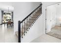 Modern staircase with black metal railing and carpeted steps at 2605 Scrapbook St, Kissimmee, FL 34746