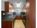 Cozy kitchen featuring wood cabinets and granite countertops at 2441 Sanford Ave, Sanford, FL 32771