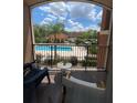 Relaxing balcony view overlooking the community pool and lush landscaping at 5518 Metrowest Blvd # 207, Orlando, FL 32811