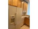 Kitchen features wood cabinets, appliances, and tile floors at 3514 Victoria Pines Dr # 148, Orlando, FL 32829