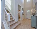 Elegant staircase with white railing and carpeted steps at 8887 Qin Loop, Kissimmee, FL 34747
