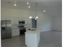 Modern kitchen with white cabinets, stainless steel appliances and an island at 531 Rhodes Dr, Deland, FL 32720