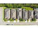 Row of houses with gray roofs and lush green landscaping at 333 Navarra Ln, Davenport, FL 33837