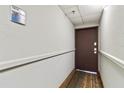 Hallway leading to condo unit with simple flooring and walls at 6165 Carrier Dr # 1214, Orlando, FL 32819