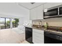 Modern galley kitchen with granite countertops and stainless steel appliances at 6165 Carrier Dr # 1214, Orlando, FL 32819