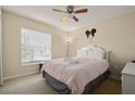 Spacious bedroom with a queen-size bed and window coverings at 619 Kensington Dr, Davenport, FL 33897