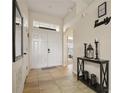 Inviting entryway with tile flooring and a console table at 619 Kensington Dr, Davenport, FL 33897
