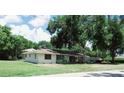 Single-story home with large yard and trees at 1050 S Main Ave, Groveland, FL 34736