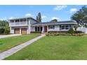 Two-story home with gray brick, updated garage doors, and a paved walkway at 515 N Boyd St, Winter Garden, FL 34787