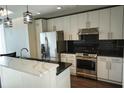 Modern kitchen with stainless steel appliances and white cabinets at 155 S Court Ave # 2310, Orlando, FL 32801