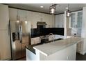 Modern kitchen with stainless steel appliances and white cabinets at 155 S Court Ave # 2310, Orlando, FL 32801