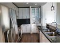 Modern kitchen with stainless steel appliances and white cabinets at 155 S Court Ave # 2310, Orlando, FL 32801