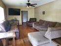Spacious living room featuring hardwood floors and ample seating at 1050 S Main Ave, Groveland, FL 34736