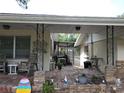 Brick patio with covered area and seating at 1050 S Main Ave, Groveland, FL 34736