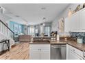 Open kitchen features granite countertops and stainless steel appliances at 618 Brunello Dr, Davenport, FL 33897