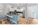 Modern kitchen with stainless steel appliances and breakfast bar at 618 Brunello Dr, Davenport, FL 33897