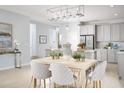 Bright dining room with light wood table and seating for six at 2280 Sirena Ln, Mount Dora, FL 32757