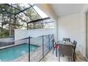 Enclosed private pool with patio furniture and dining area at 17317 Hidden Forest Dr, Clermont, FL 34714