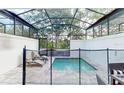 Enclosed private pool with patio furniture at 17317 Hidden Forest Dr, Clermont, FL 34714