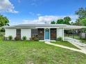 House exterior featuring solar panels, modern accents, and a landscaped yard at 1567 Fort Smith Blvd, Deltona, FL 32725