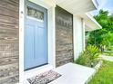 Stylish front door with wood accents and a welcoming mat at 1567 Fort Smith Blvd, Deltona, FL 32725