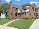 Brick home with updated windows and landscaping at 1689 Lakeshore Dr, Eustis, FL 32726