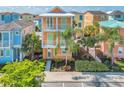 Two-story house with orange exterior, green accents, and palm trees at 8016 Flip Flop Way, Kissimmee, FL 34747