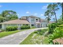 Two-story house with a circular driveway and lush landscaping at 9 Stone Gate N, Longwood, FL 32779